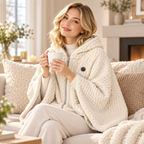 Woman relaxing on the sofa in an Off-White heated shawl wrap