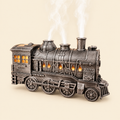 Silver vintage steam train aroma diffuser and essential oil humidifier with remote control, glowing cabin windows and rising steam mist