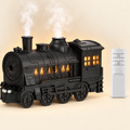 Black vintage steam train aroma diffuser and essential oil humidifier with remote control, glowing cabin windows and rising steam mist